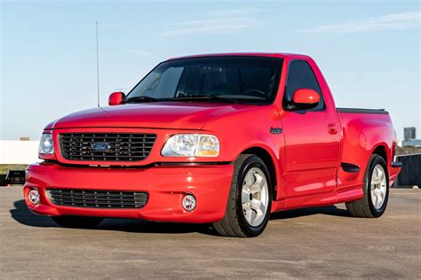 Front view of a 2001 Ford SVT Lightning pickup truck, showcasing its aggressive styling and supercharger emblem.