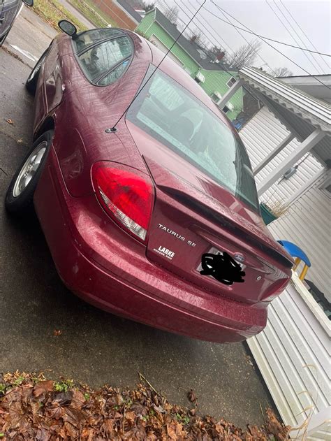 A well-maintained 2006 Ford Taurus parked in a driveway, showcasing its classic sedan design.
