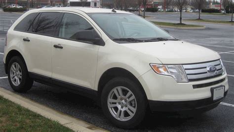 Front view of a silver 2008 Ford Edge parked on a city street