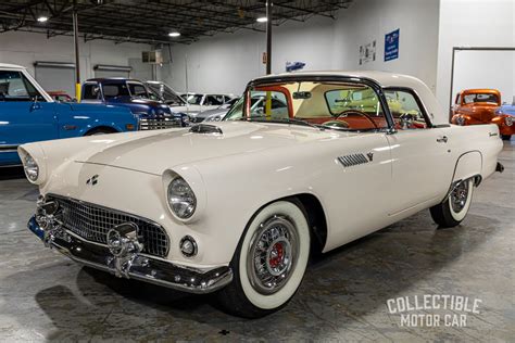 Iconic 1955 Ford Thunderbird parked on a scenic road, showcasing its classic design
