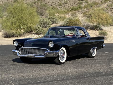 A pristine 1957 Ford Thunderbird in a classic color, showcasing its iconic design