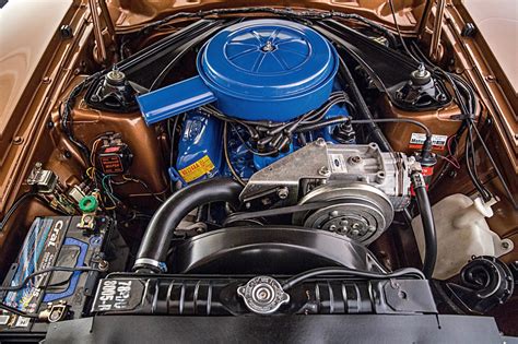 Close-up of the inline-six engine bay of a 1969 Ford Maverick, showcasing its mechanical components.