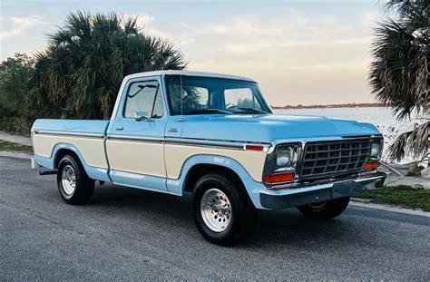 Iconic 1979 Ford F100 cruising down a scenic road