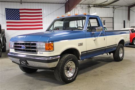 A well-maintained 1990 Ford F-150 parked outdoors, showcasing its classic design.