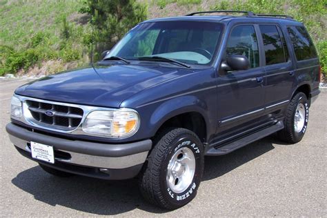 A classic 1998 Ford Explorer parked outdoors, showcasing its rugged design