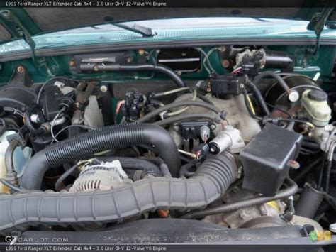 Open hood of a 1999 Ford Ranger truck showing the engine