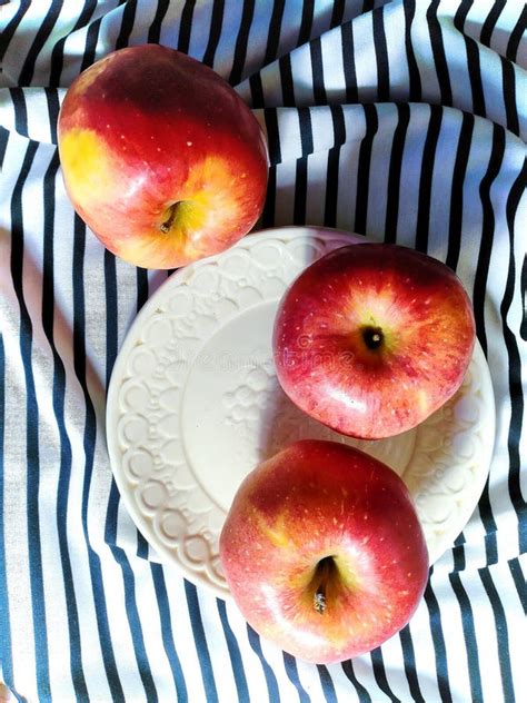 Apples On White Plate On Wooden Table Stock Photo Image of wooden
