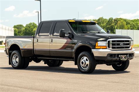 A powerful 2000 Ford F-350 parked on a gravel lot, showcasing its imposing presence and heavy-duty design.