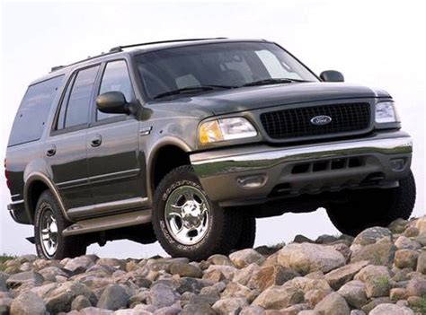 Mechanic performing maintenance on a black 2002 Ford Expedition