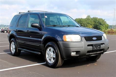A clean 2003 Ford Escape parked outdoors, showcasing its classic SUV design.
