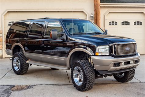 A powerful 2004 Ford Excursion parked on a scenic road