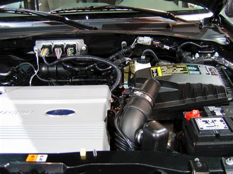 Close-up of the engine bay of a 2006 Ford Escape Hybrid, highlighting hybrid components