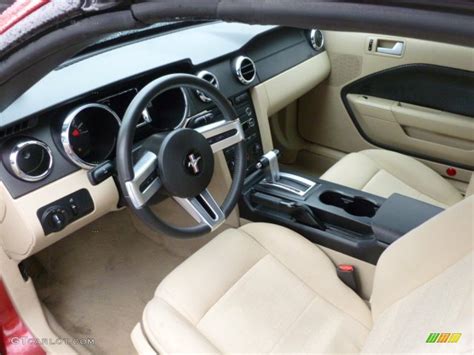 The interior of a 2008 Ford Mustang Convertible, showing the dashboard and comfortable seating.