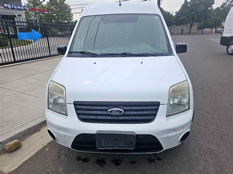 Customized interior of a 2010 Ford Transit Connect XLT with shelving and organization for a trade