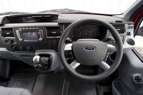 Interior of a 2010 Ford Transit van, showcasing its spacious cargo area and driver's cockpit.