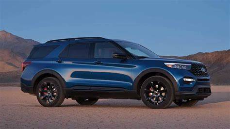 Side profile of a 2022 Ford Explorer ST driving on a scenic road