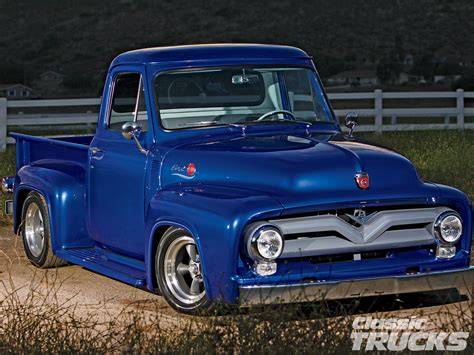 A classic 1955 Ford F100 pickup truck in pristine condition