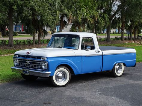 Iconic 66 Ford F100 pickup truck parked outdoors, showcasing its classic design
