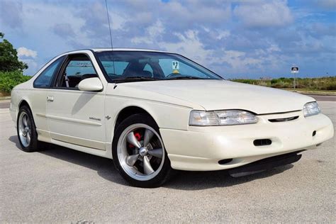 Front three-quarter view of a 1995 Ford Thunderbird, showcasing its sleek lines and classic coupe design