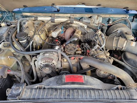 Engine bay of a 97 Ford F-350 showcasing its powerful capabilities