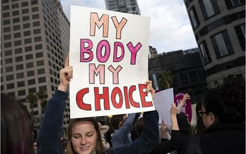 A Meme With A Picture Of A Man Holding A Sign That Says, 'My Body, My Choice'