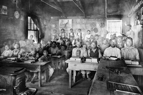 A Native American student in a classroom in the early 1900s