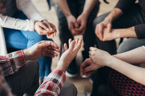 A group of people sitting in a circle during a support group session.
