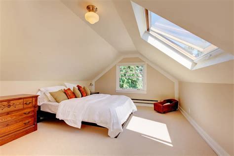 Attic bedroom with skylights and windows