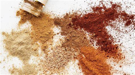 adding spices to pilaf