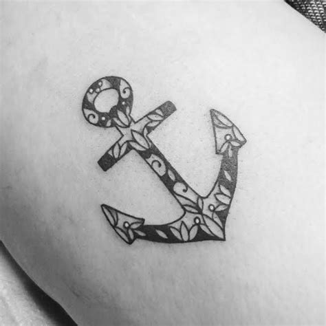 Side tattoo of an anchor with water designs by Suzanna