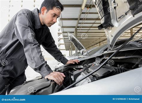 Auto Mechanic Checking a Car