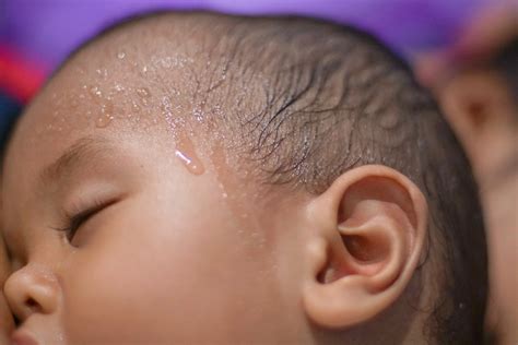 Baby Sweating: 7 Common Causes & Solutions