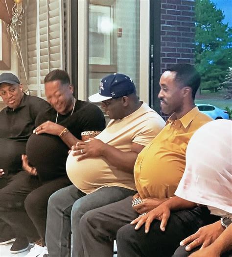 Men receiving advice from an older man at a baby shower