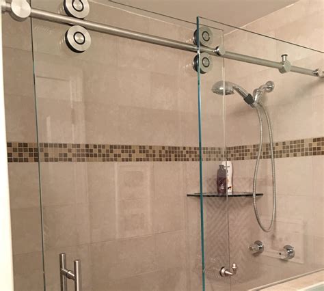 A frosted glass barn door for the shower adds a modern touch to a traditional ho... 1000