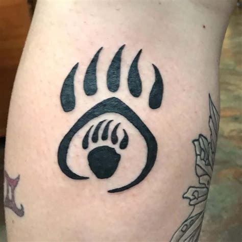 Tribal bear paw prints tattoo on biceps Tattoos Book