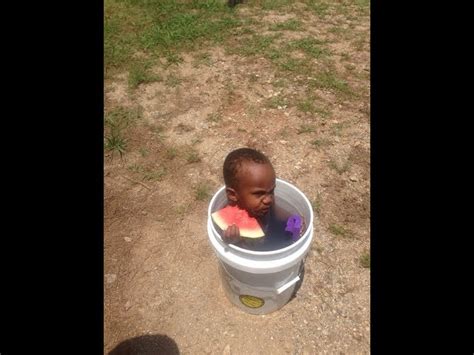 Black Kid In Bucket With Watermelon