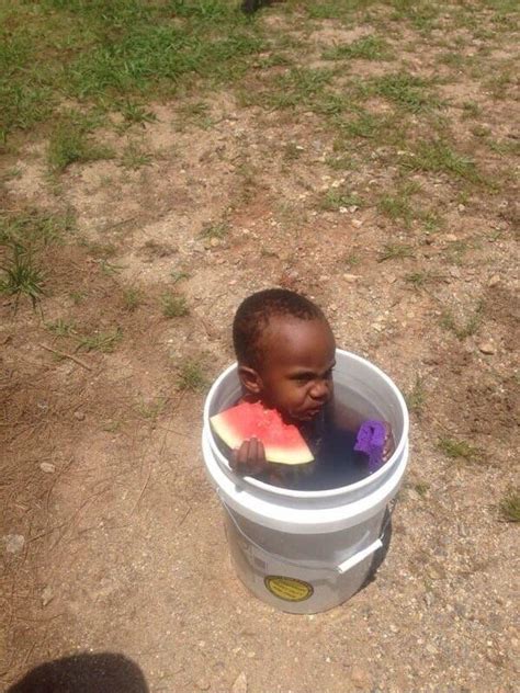 Black Kid Sitting In A Bucket