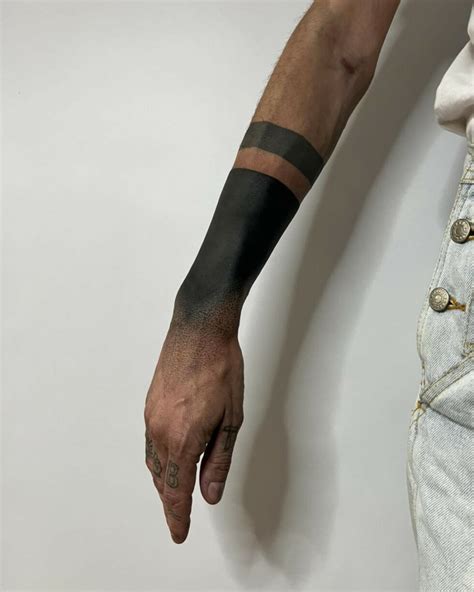 Blacking Out Arm Tattoo