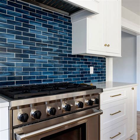 The reflective quality of this kitchen's blue glass tile backsplash is a perfect... Blue glass