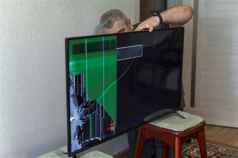 Broken TV screen with tools