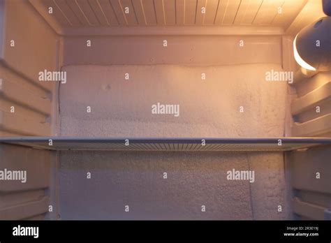 Broken refrigerator with ice inside