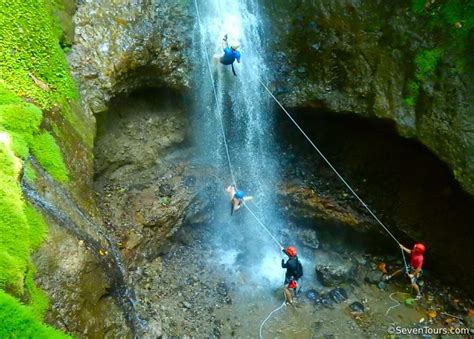 Canyoning waterfall rappelling