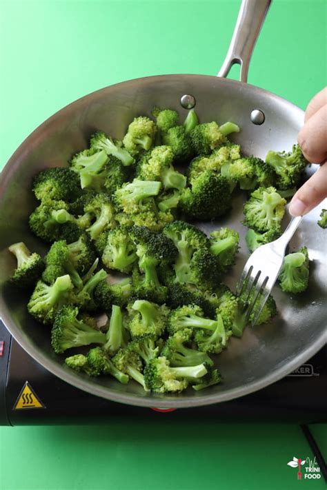 Checking the doneness of broccoli with a fork