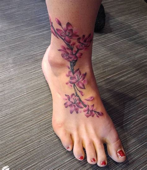 Cherry blossom tattoo on foot Foot tattoos, Tattoos