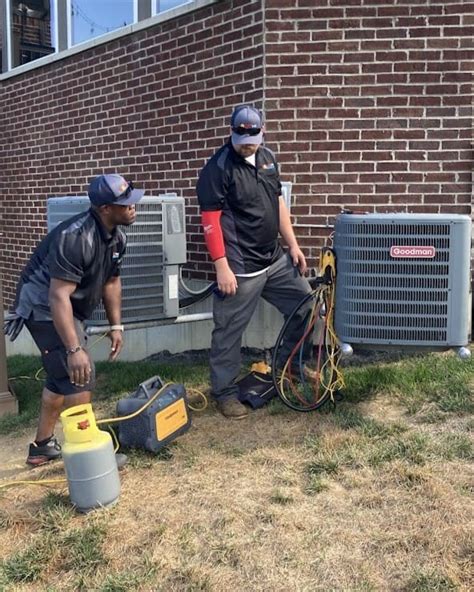 Cincinnati AC Repair Technician Examining Unit