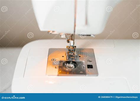 Close up of a sewing machine needle and thread