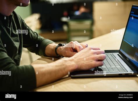 Close-up Of A Man Using A Laptop For Work