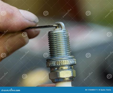 Close-up of a spark plug being checked