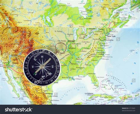 A brss compass on an old map showing the North Atlantic ocean and the