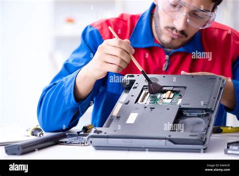 Computer Technician Troubleshooting a Laptop
